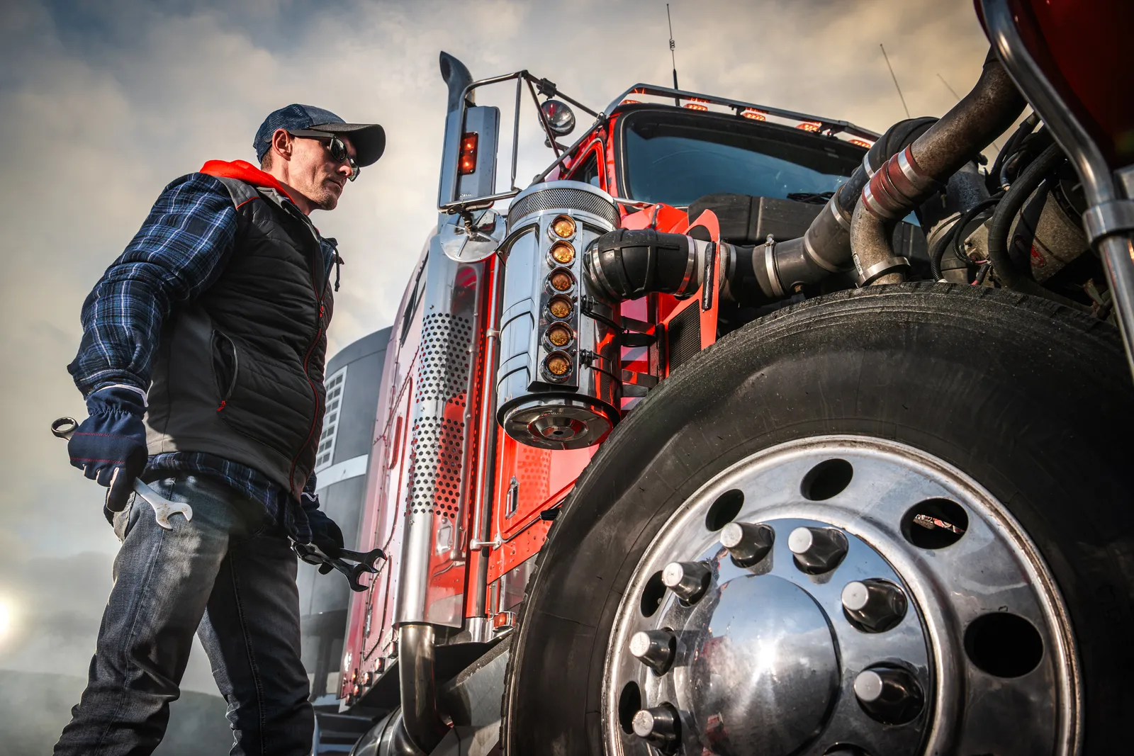 Mechanic inspecting a commercial truck wheel, maintenance records are key evidence in Florida truck accident claims